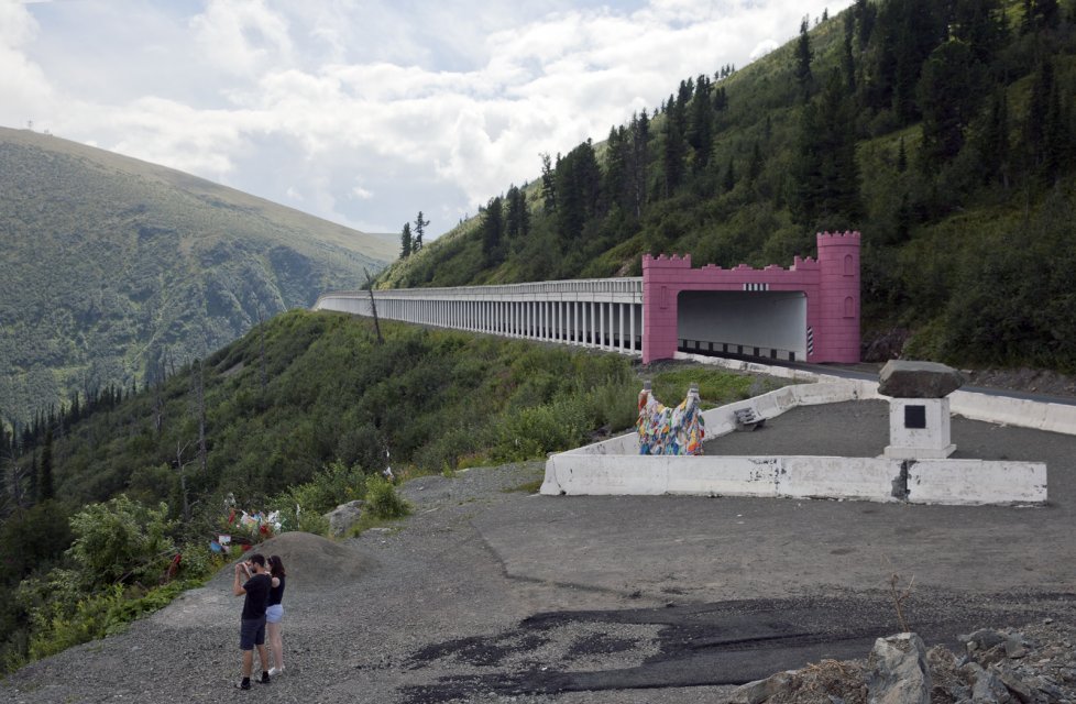 Tourists take a picture near The Shelf - an anti-avalanche tunnel at Buibinsky Pass in the Sayan Mountains that separate Tuva from the neighboring Krasnoyask Territory. A prominent Russian politician Lt Gen Alexander Lebed who came third in the 1996 presidential election and later became governor of Krasnoyask Territory, died in a helicopter crash here in 2002.