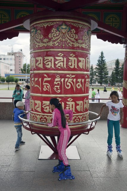 Kids playing with the Buddhist prayer wheel in the Tuvan capital Kyzyl's main square - the Arat Square. Arat is Tuvan for "stock farmer". After Tuva has formally joined the Soviet Union in 1944, all monks were prosecuted and temples completely destroyed to help Communist ideology take hold instead. After the breakup of the Soviet Union, Buddhism has seen a controversial revival in Tuva, although it's the religion's power consolidating potential rather than its true meaning that's being prioritized by the authorities all over Russia irrespective of whether it's Christianity, Islam or Buddhism.