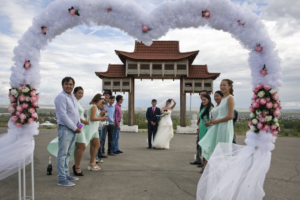 Choiganmaa, a journalist, and Shoraan Kuular, a stock farmer, celebrate their wedding with friends at a symbolic gateway to Tuva outside the capital Kyzyl where its future railway station is supposed to sit. Tuva was a vassal of the Chinese Qing Empire until 1912 and the Chinese influence, although largely forgotten, can still sometimes spring up in new monuments such as this one.