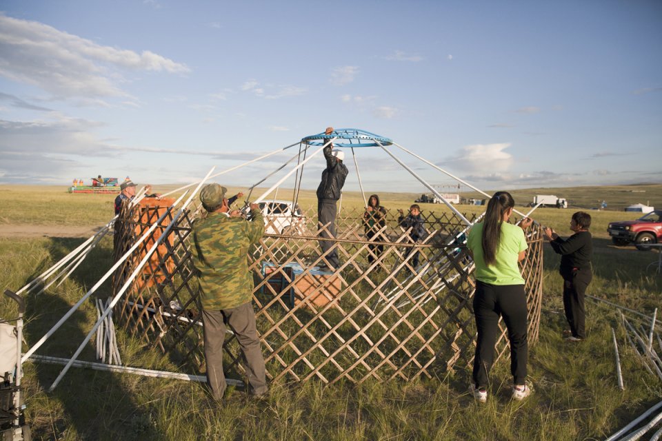 Building a yurt for the yearly stock farmers' festival Naadym (pronounced 'Nah-Dim) which includes various competitions such as the Best Yurt, horse racing, arching, wrestling and cooking contests. Tos-Bulak, Tuva, Russia.