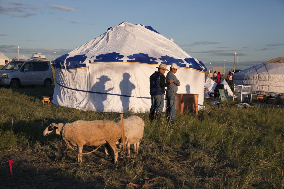 Farmers prepare for the yearly Naadym festival (pronounced 'Nah-Dim), an important element of today's Tuvan identity which includes various competitions such as Best Yurt, horse racing, arching, wrestling and cooking contests. During Soviet era, Naadym as well as other Tuvan folk activities were banned to help merge them into a single Soviet identity. Tos-Bulak, Tuva, Russia.