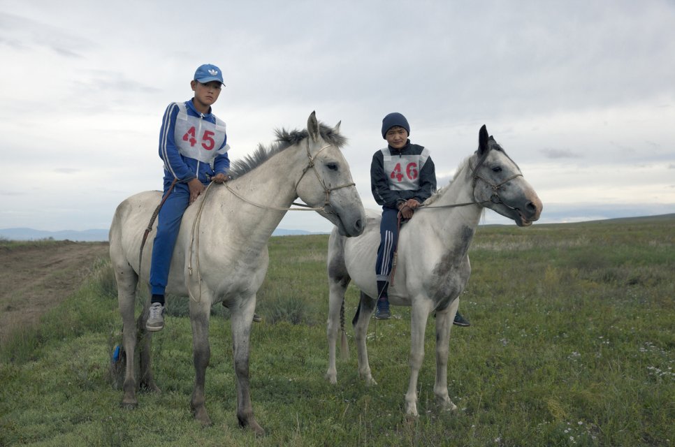 Brothers Salgyn, 14, and Kheimer, 13, Dongak prepare for the yearly 15-km horse race as part of Naadym farmers' fest. Both Salgyn and Kheimer have been jockeys since the age of 8. Tuvan race rules allow neither saddles nor helmets. "If we wore them, we would be laughed at", the brothers said. Tos-Bulak, Tuva, Russia.