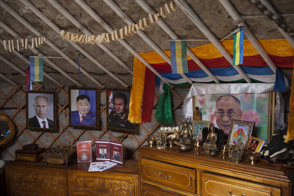 Inside a yurt participating in the Best Yurt contest as part of the yearly Naadym farmers' festival; portraits are those of Russian president Vladimir Putin, Tuvan governor Sholban Kara-Öol, Russian defense minister and a native of Tuva Sergei Shoigu, and Dalai-Lama. This yurt eventually won the contest. Tos-Bulak, Tuva, Russia.