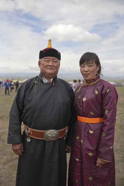 Oleg Khertek, head of Tuva's Erzin district bordering Mongolia, with his deputy Bayirma Izhigin attending the yearly Naadym farmers' festival in folk costumes. These were banned during the Soviet era but are now worn only on special occasions such as the Naadym fest. Tos-Bulak, Tuva, Russia.