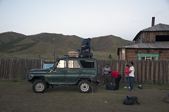 Ertine Bandan (on the roof of the vehicle) unloads the luggage near the home of Bayir-Kys Banchyk - director of the village hall (in red sleeveless jacket) whom he gave a ride - in front of her home in Kachyk, a remote and hard-to-get village near the Mongolian border. The isolated Kachyk community has about 300 residents, partly living in the village itself, partly - at nomadic stations in the surrounding valleys. According to Moscow-based sociologist Artemiy Pozanenko who has been studying spacially isolated communities in the post-Soviet world, they tend to be more cohesive and self-sustainable because in part of unlimited access to natural resources around them and absence of regulatory authorities.