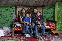 Alimaa and Ertine Bandan, 28 and 29, with their sons Bimdorch, 9, and Sayin-Belek, 3, posing for picture in their family yurt. In summer, they live in this yurt in the Kachyk river valley - a remote area in southeastern Tuva bordering Mongolia. In fall, they return to the nearest big village Naryn - some 100 km away - where they also have a house and where Sayim-Belek goes to school. Together with Ertine's parents and other relatives, the Bandan family keeps more than 2,000 stock - mostly sheep, cows and horses. They have about 80 hectares of private land and rent more land for a winter station. Alimaa also makes traditional Tuvan skin and wool clothes mostly for family use. Says Ertine: "I like it more when we are here in the valley, living in our yurt, I am my own boss here, there is no authority above. We all know each other here and live together peacefully".