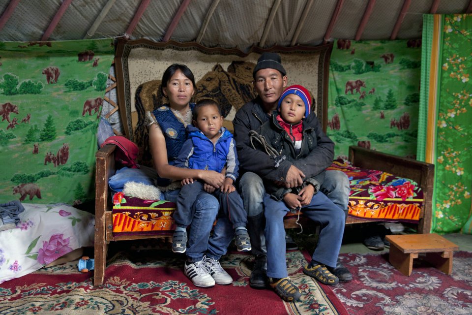 Alimaa and Ertine Bandan, 28 and 29, with their sons Bimdorch, 9, and Sayin-Belek, 3, posing for picture in their family yurt. In summer they live in this yurt in the Kachyk river valley - a remote area in southeastern Tuva bordering Mongolia. In fall, they return to the nearest big village Naryn - some 100 km away - where they also have a house and where Sayim-Belek goes to school. Together with Ertine's parents and other relatives, the Bandan family keeps more than 2,000 stock - mostly sheep, cows and horses. They have about 80 hectares of private land and rent more land for a winter station. Alimaa also makes traditional Tuvan skin and wool clothes mostly for family use. Says Ertine: "I like it more when we are here in the valley, living in our yurt, I am my own boss here, there is no authority above. We all know each other here and live together peacefully".