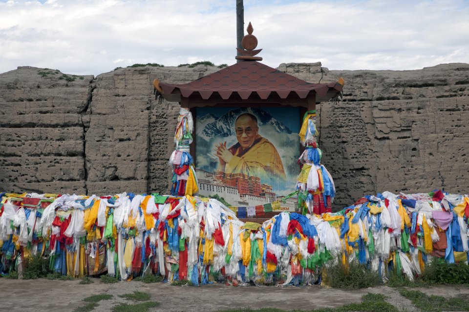 A portrait of Dalai Lama with prayer ribbons and blessing scarves at what remains from a 1908 Buddhist sanctuary Ustuu-Khure outside Chadan in western Tuva, which at the time of its completion was an important center of the Tuvan nation-building: the first Tuvan alphabet was developed here and the first coin minted. The monastery was built at the order of the local noyon (tribal ruler) Khaidyp - the adoptive father of the future founder and first prime minister of independent Tuva Mongush Buyan-Badirgi. After Buyan-Badirgi was arrested and murdered after a coup staged by his Communist-leaning subordinates, this monastery was destroyed and all monks prosecuted, some of them executed. The monastery was revived in 2008 with the support of the then Emergencies MInister and a native of Chadan Sergei Shoigu - Russia's current defense minister.
