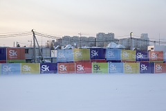 A temporary fence decorated with Skolkovo logo, separating the innovation center from the nearby Moscow suburbs, Skolkovo, Russia, January 2018