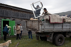 Villagers and members of Bandan family unload their truck at a community warehouse in Kachyk - an isolated village in southeastern Tuva bordering Mongolia - after returning from the yearly stock farmers' festival Naadym. This community won the Best Yurt competition and because they prepared and made that yurt together, the prize - 90,000 RUB (ca. $1,400) - will be shared according to everyone's contribution.