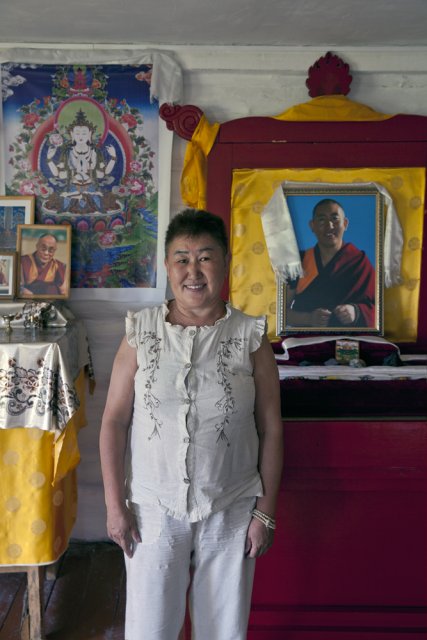 Chechekmaa Ishina, 53, poses for picture in front of an altar in the house in Chadan she has built on her own savings for her teacher - Tibetan monk Shivalkha Rinpoche. Reverend Rinpoche has lived in Tuva for 7 years and has become very popular among Tuvan Buddhists until he was deported at the order of the Federal Security Service in 2015.